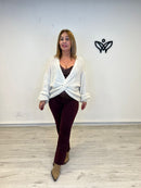 Jersey de punto escote en pico con nudo beis