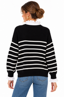 Jersey de rayas negras y blancas con efecto camisa y botones dorados