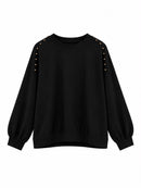 Sudadera de mujer negra con cuello redondo y tachuelas doradas